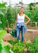 © JackF - Cheerful woman watering young plants on her plantation. High quality photo