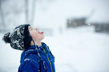 Poster - Cute boy playing with teddy bear in the snow, winter time. Little toddler playing with toys on snowy day