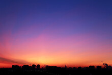 Sunrise Over The City, Scenic View. Pink-blue Sky In Soft Colors Sky Above Silhouettes Of High-rise Buildings, Colorful Cityscape For Background