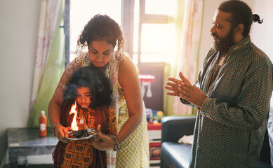 Poster - Indian family celebrating religion hindu event at home - Soft focus on man face