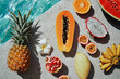© luengo_ua - Vacation and diet concept. Tropical exotic colorful fruits near water in swimming pool.