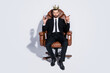 © deagreez - Full body photo of handsome business guy sit office chair hold whiskey glass cuban cigar luxury chief golden crown wear black blazer pants tie shirt shoes suit isolated grey background