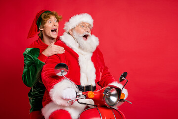 Wall Mural - Profile photo of elf santa ride moped open mouth look empty space wear x-mas costume coat cap isolated red color background