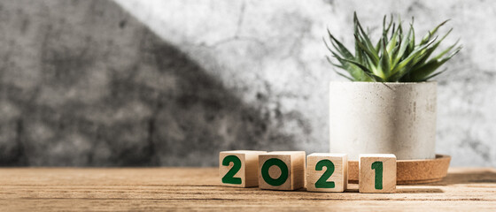 Aufkleber - 2021 happy new year on wood block on wood table and concrete wall with sunlight from window.hope new year concept