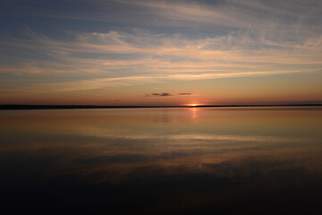 Wall Mural - Sunset glow in the clear sky in the silence of nature
