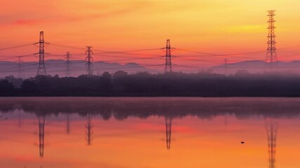 Wall Mural - electricity pylon or high-voltage transmission towers on the hill with reflection in the morning tra
