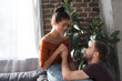 © LIGHTFIELD STUDIOS - young man holding hand and talking to upset woman crying while sitting on sofa