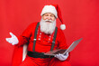 Close up photo of funny funky overweight santa claus using laptop search christmas season discounts type congratulations isolated over red background.