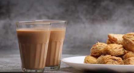 Wall Mural - indian khari or kharee or salty Puff Pastry Snacks, served with indian hot tea.