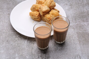 Wall Mural - indian khari or kharee or salty Puff Pastry Snacks, served with indian hot tea.