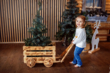 Wall Mural - a child in a new year's photo Studio, the new year is coming, a girl is laughing, playing