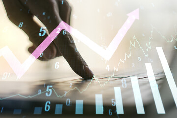 Multi exposure of abstract creative financial graph with upward arrow and hand typing on laptop on background, forex and investment concept