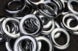 Glossy nickel-plated or chrome-plated Eyelets for attaching curtains in the design workshop.