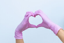 Female Hands In Pink Gloves Show A Heart