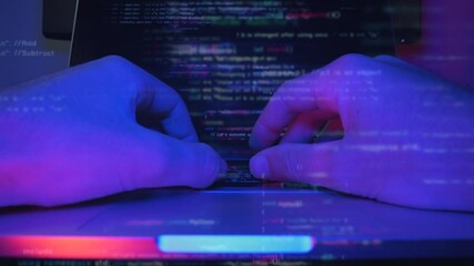 Man is designing web software. Coding on screen. Web developer hands are typing code and programming on screen laptop. Hacker works online and testing virus security system. Develop internet project