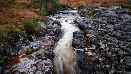 long exposure shot of the waterfalls in glen etive near loch etive and the entrance to glencoe and rannoch moor in the argyll region of the highlands of scotland during autumn