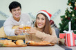 © chinnarach - close up group of asian lover couple holding glass of wine and make clinking each other at dining table to celebrate christmas and happy new year festival at home for lifestyle people concept