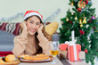 © chinnarach - close up young asian woman smiling with happiness at dining table in living room at house for chrsitmas celebration and holiday lifestyle concept