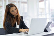 © chinnarach - close up young businesswoman typing on laptop to check e-mail or create report during use smartphone to talk with manager or customer for multitasking and busy job concept