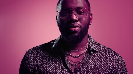 Wall Mural - African american man laughing in studio. Afro guy smiling on pink background