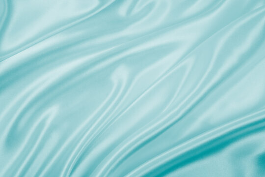 Wall Mural - Photography of beautiful wavy turquoise silk satin luxury cloth fabric, abstract background design.