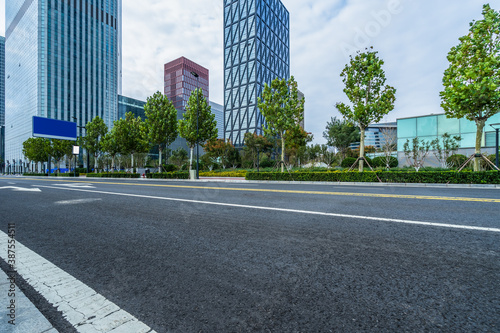 Fotomural empty urban road with modern building in the city.