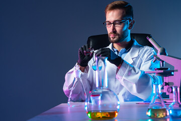 Poster - laboratory technician makes experiments. tubes on the laboratory technician table. scientist at work
