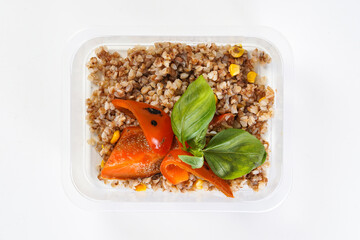 Buckwheat with corn and bell pepper in a lunch box. Healthy lunch to go