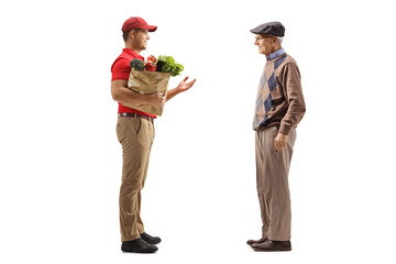 Sticker - Full length profile shot of a delivery guy with a grocery bag talking to an elderly male customer