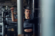 © zorandim75 - Young fitness woman execute exercise with exercise-machine in gym.