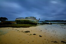 Wreck Boat At Low Tide In Brittany. France