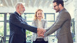 © Bojan - Mixed age group of business professionals showing their unity by putting their hands together
