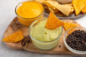 Close-up view of mexican corn nachos with sauces on white background. Food concept.