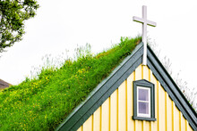 Hof, Iceland Church Closeup That Was The Last Build In Traditional Turf Style, Hofskirkja, Building Roof Covered In Green Grass And Cloudy Sky Background