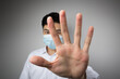 © christianchan - Man with a mask open the hand. Say no, stop, keep away concepts