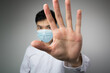 © christianchan - Man with a mask open the hand. Say no, stop, keep away concepts
