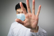 © christianchan - Man with a mask open the hand. Say no, stop, keep away concepts