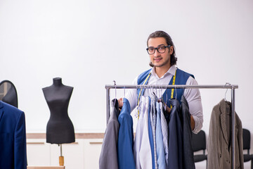 Young male tailor working at workshop