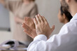 © fizkes - Crop close up of diverse employees applaud celebrating company business success at meeting. Excited workers clap hands greeting thanking coach or trainer for presentation. Acknowledgement concept.