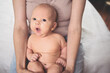 © Алина Троева - Cute emotional funny smiling newborn little baby infant boy sitting on mother hands. Healthy child