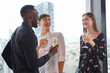 © torsakh - Young teen business people enjoy party celebration and talking with friends or coworker and relax drinking win or champagne on roof top building