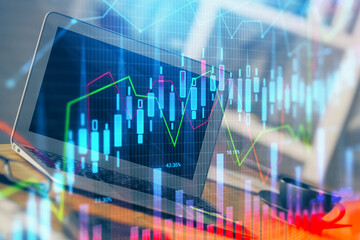 Stock market graph and table with computer background. Multi exposure. Concept of financial analysis.