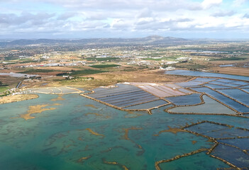 Aerial view of salt pans at the beautiful Algarve coast in Portugal seen on a flight to Faro airport