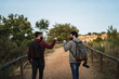 © MiguelAngelJunquera - Dos chicos jovenes chocando puño en la sierra de sevilla