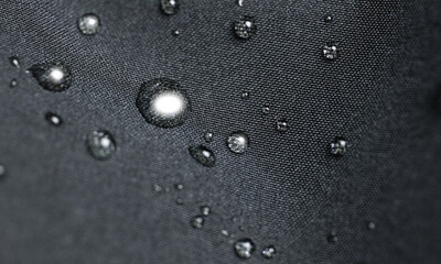 Waterproof fabric, clothing with waterdrops. Rain drops on water resistant textile waterproof coating