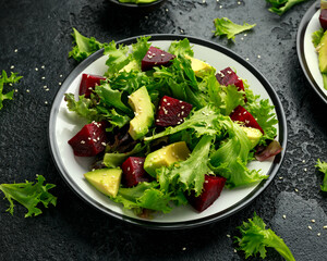 Wall Mural - Vegetarian avocado and beet salad in plate. Healthy vegan food