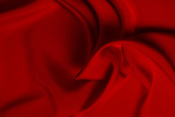 Red silk or satin luxury fabric texture can use as abstract background. Top view.