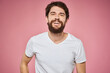 © SHOTPRIME STUDIO - man in white t-shirt gesturing with his hands emotions fun pink background