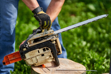 Lumberjack servicing his chainsaw