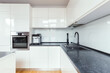 © Photographee.eu - White furniture and grey appliance in kitchen